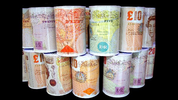 A stack of money tins that are designed to look like rolls of various British bank notes