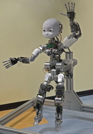 A humanoid robot designed to replicate a young child in movement and appearance. It is on a frame as the feet aretoo small to walk on.