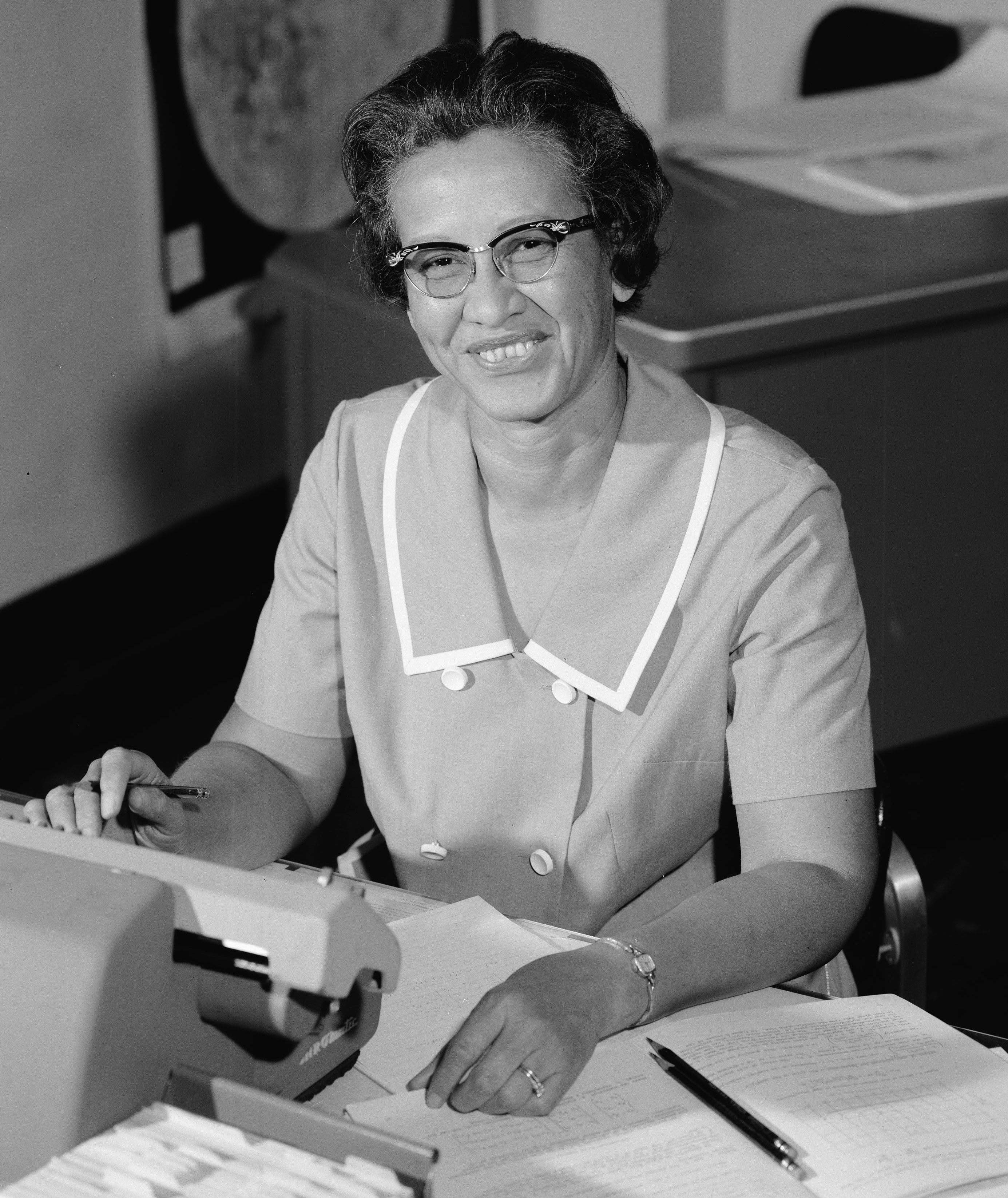 Katherine Johnson working at her desk within NASA
