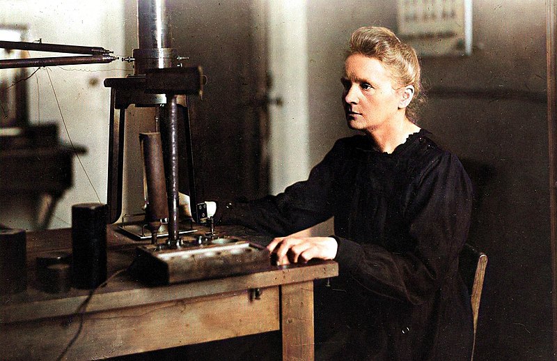Marie Curie using some scientific equipment