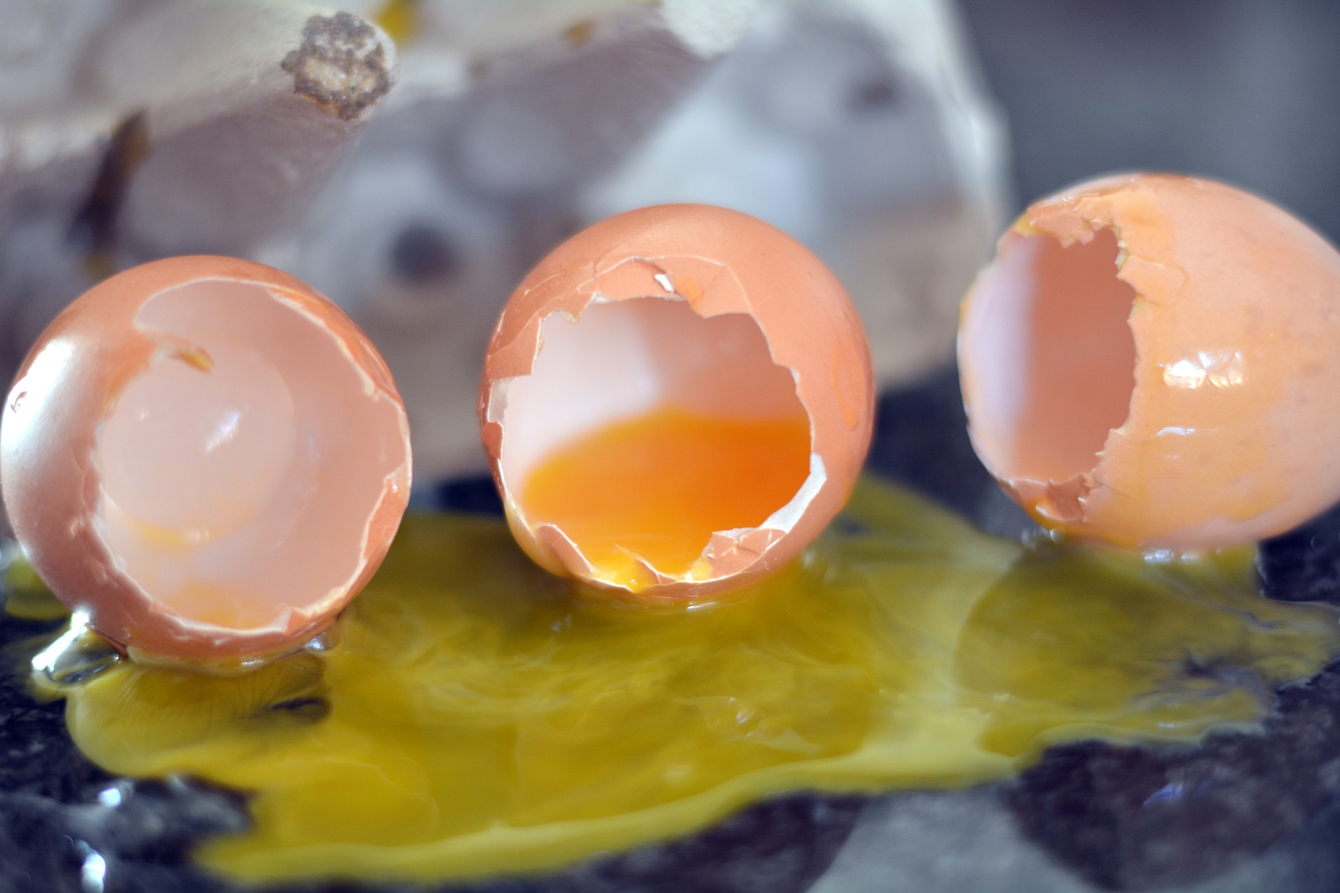several broken eggs on a hard surface.