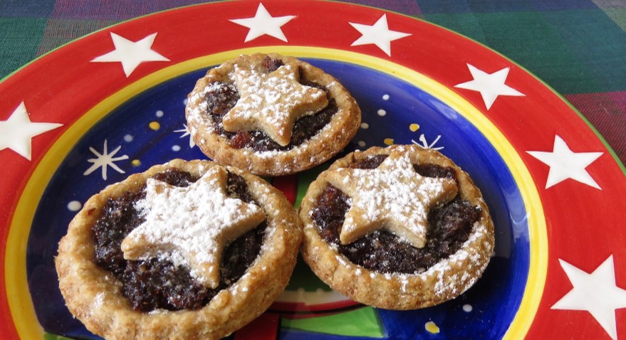 Three mince pies displayed on a plate